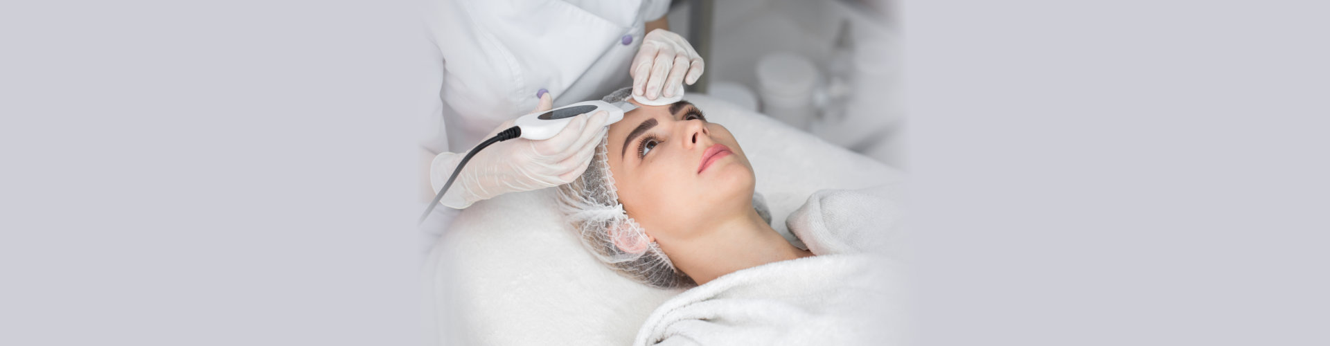 beautiful woman receiving ultrasound favitation facial peeling